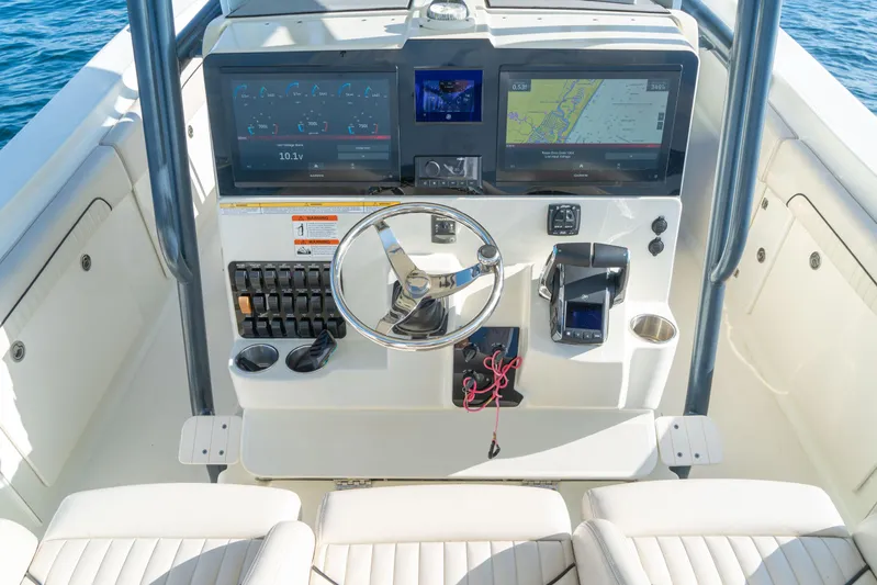  Yacht Photos Pics 2022 Hydra-Sports 3400 boat dashboard with navigation screens and steering wheel.