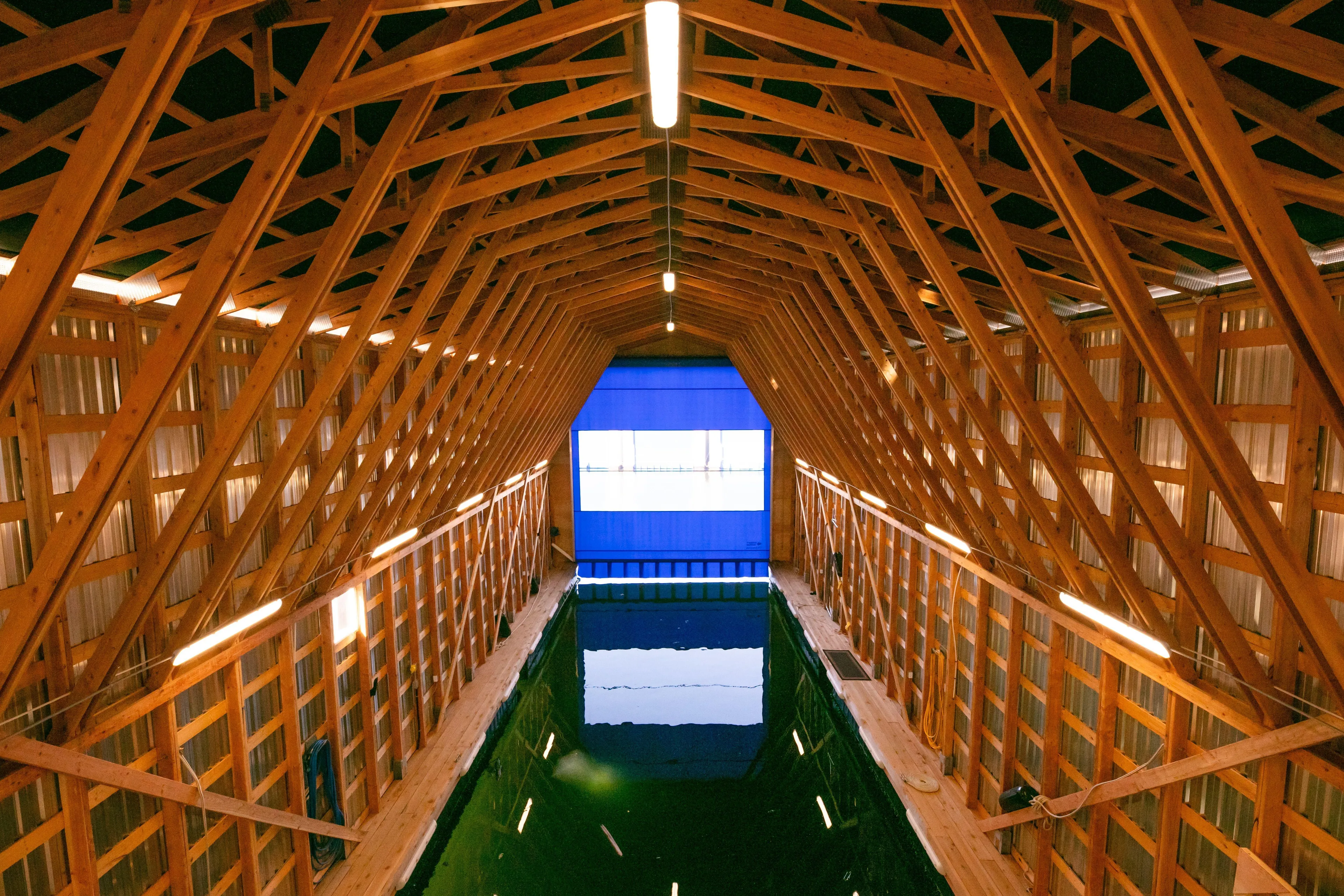  Yacht Photos Pics Modern wooden boathouse interior with water channel, Custom OBMG Boathouse 2025 model.