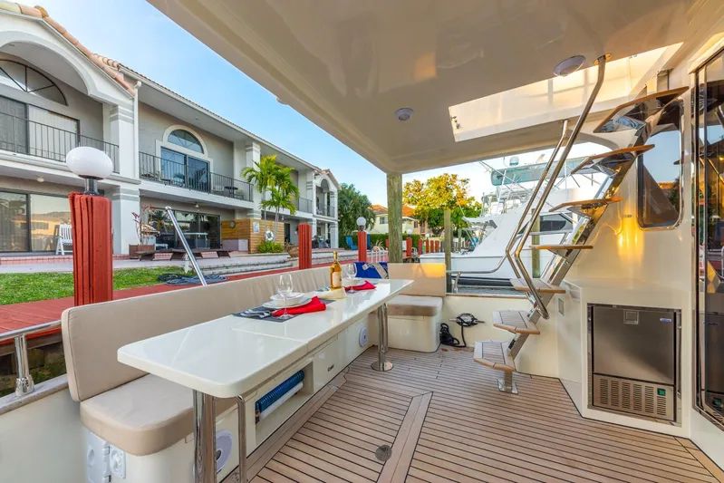  Yacht Photos Pics Luxurious Norseman 45 FreeOcean yacht interior, featuring elegant seating and modern amenities, docked by waterfront homes.