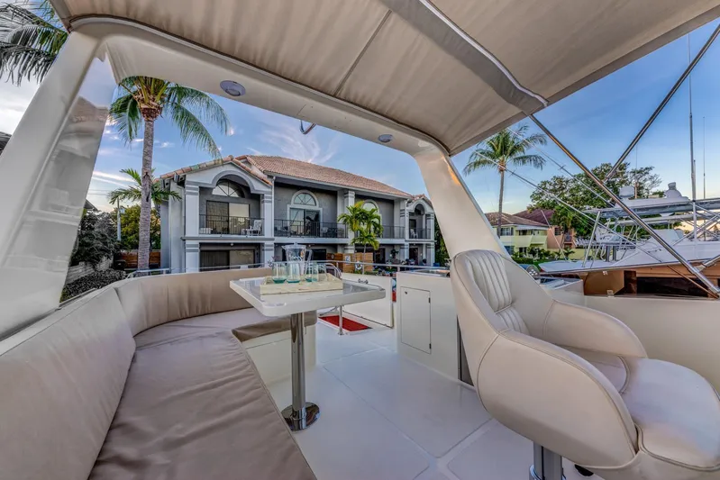  Yacht Photos Pics Luxurious 2025 Norseman 45 FreeOcean yacht interior with elegant seating and table, docked near waterfront homes.