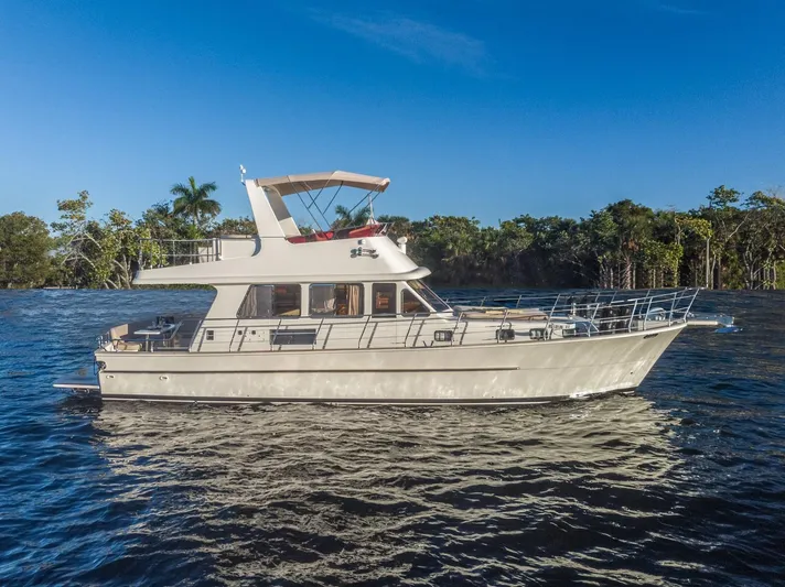  Yacht Photos Pics Norseman 45 FreeOcean 2025 yacht cruising on a sunny day, surrounded by lush greenery.