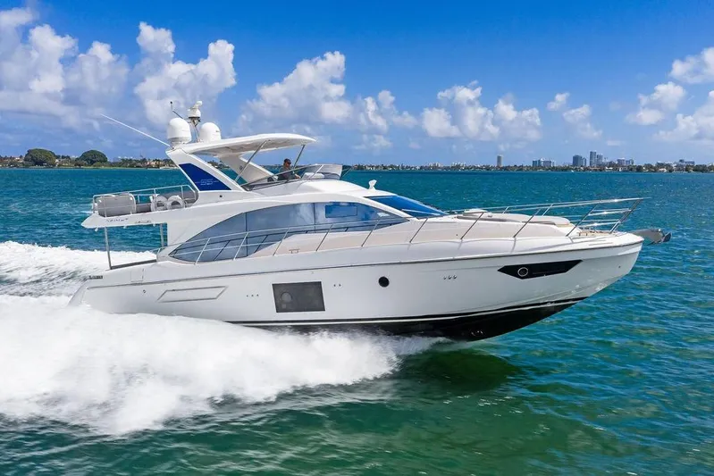 Mi Boat Yacht Photos Pics Luxury 2019 Azimut yacht cruising on clear blue waters under a sunny sky.