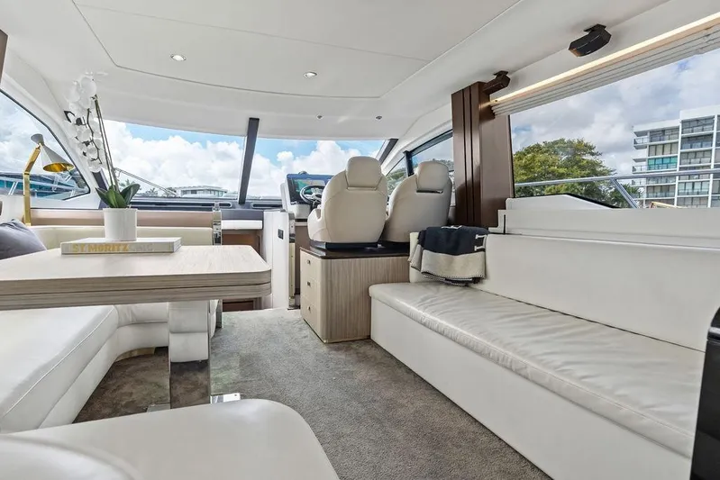 Mi Boat Yacht Photos Pics Luxurious 2019 Azimut yacht interior with modern seating, table, and helm, featuring panoramic windows.