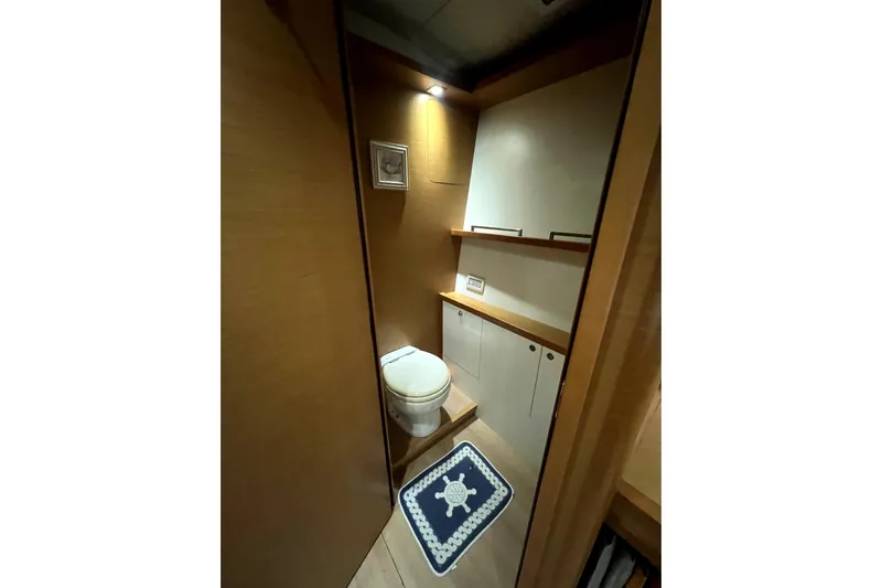 Capricho Yacht Photos Pics Luxurious bathroom in 2011 Lagoon 560 yacht with wooden cabinetry and nautical-themed decor.