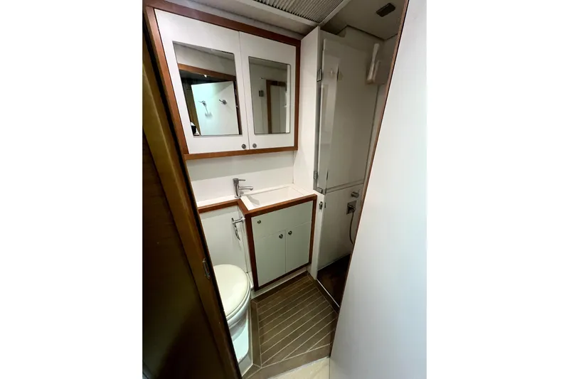 Capricho Yacht Photos Pics Bathroom interior of 2011 Lagoon 560 yacht with modern fixtures and wood accents.