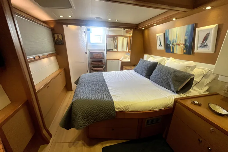 Capricho Yacht Photos Pics Luxurious cabin interior of 2011 Lagoon 560 yacht with cozy bed and elegant decor.