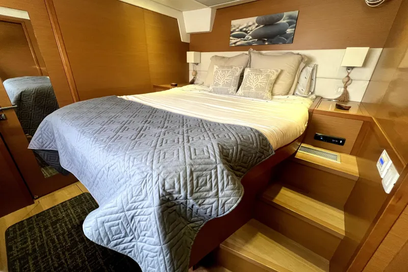 Capricho Yacht Photos Pics Luxurious bedroom interior of 2011 Lagoon 560 yacht with cozy bedding and elegant decor.