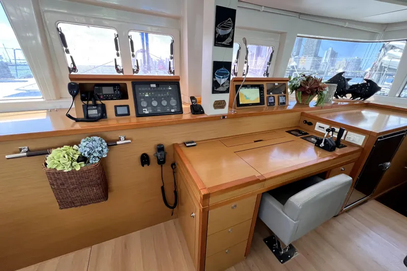 Capricho Yacht Photos Pics Luxurious 2011 Lagoon 560 yacht interior with navigation equipment and elegant wooden finish.