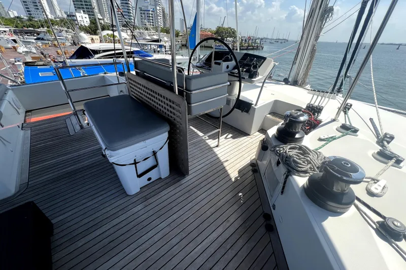 Capricho Yacht Photos Pics Lagoon 560 yacht deck, 2011 model, featuring steering wheel and marina view.