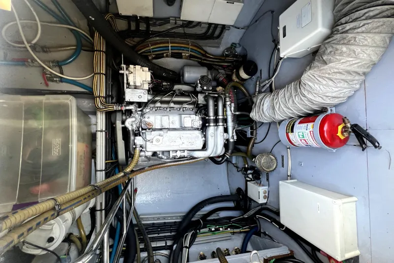Capricho Yacht Photos Pics Engine room of a 2011 Lagoon 560 yacht with visible machinery and fire extinguisher.