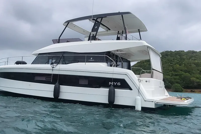  Yacht Photos Pics 2024 Fountaine Pajot MY6 yacht on water, showcasing sleek design and modern features.