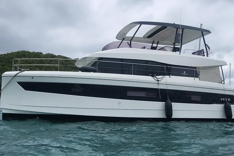  Yacht Photos Pics 2024 Fountaine Pajot MY6 yacht on water, sleek design, overcast sky.
