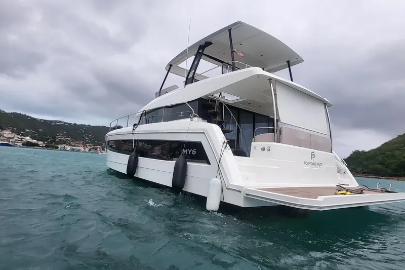  Yacht Photos Pics 2024 Fountaine Pajot MY6 yacht on water, showcasing sleek design and spacious deck.
