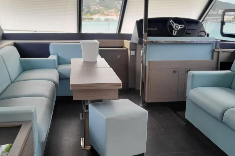  Yacht Photos Pics Luxurious interior of 2024 Fountaine Pajot MY6 yacht with modern seating and helm station.