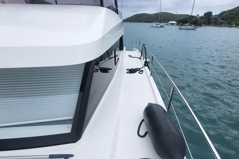  Yacht Photos Pics 2024 Fountaine Pajot MY6 yacht deck with ocean view and moored boats.