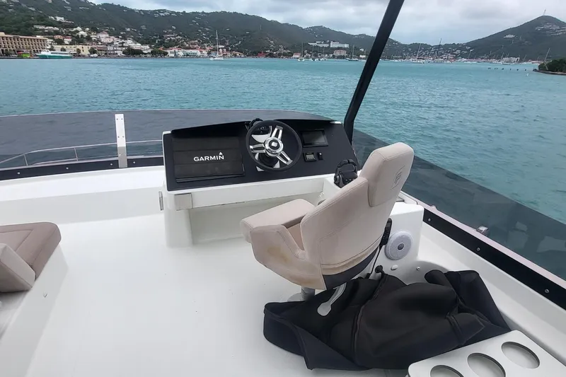  Yacht Photos Pics 2024 Fountaine Pajot MY6 yacht helm with Garmin navigation, overlooking scenic coastal waters.