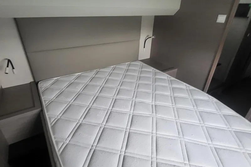  Yacht Photos Pics 2024 Fountaine Pajot MY6 yacht interior with a neatly made bed and modern design.