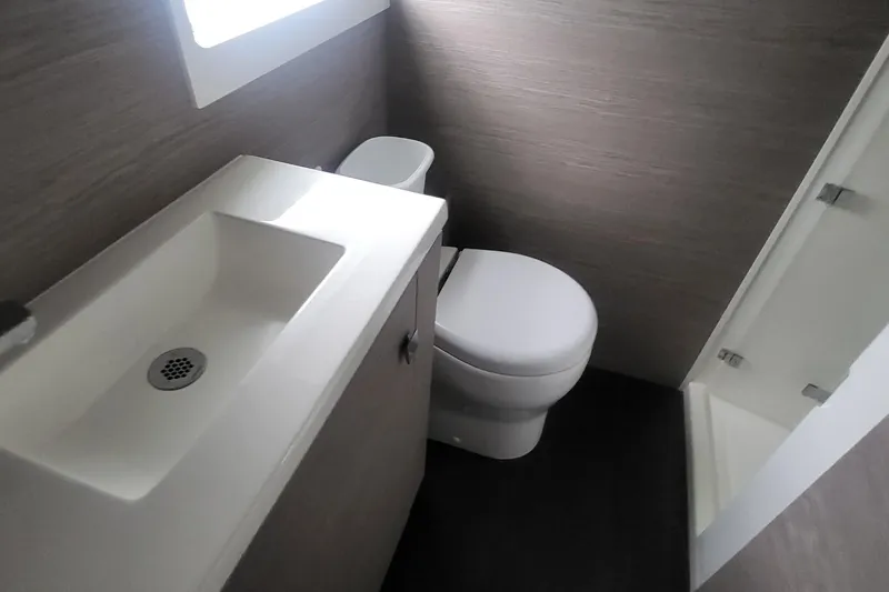  Yacht Photos Pics 2024 Fountaine Pajot MY6 yacht bathroom with modern sink, toilet, and shower.