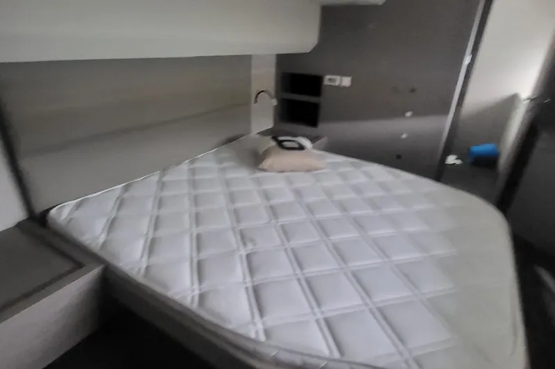  Yacht Photos Pics 2024 Fountaine Pajot MY6 yacht bedroom with modern design and comfortable bedding.