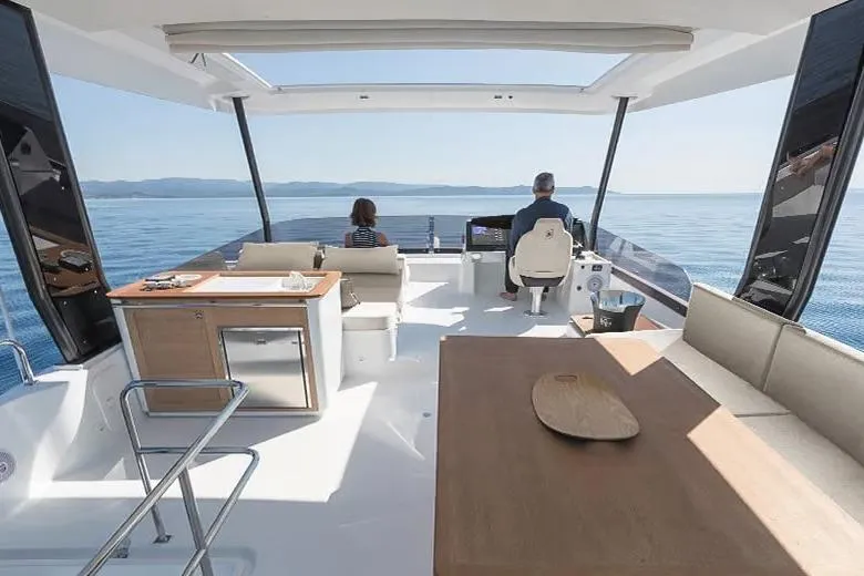  Yacht Photos Pics 2024 Fountaine Pajot MY6 yacht interior with ocean view, featuring modern seating and helm.