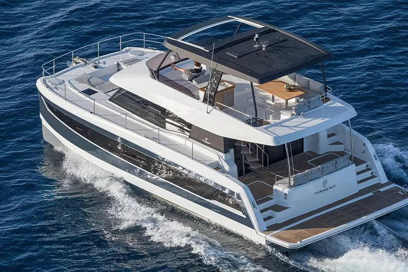  Yacht Photos Pics 2024 Fountaine Pajot MY6 yacht cruising on open sea, showcasing luxury and modern design.