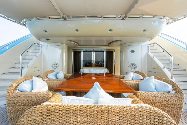 Aquamarina Yacht Photos Pics Luxury yacht deck with wicker seating, wooden table, and stairs; ISA Isa 470, 2007 model.