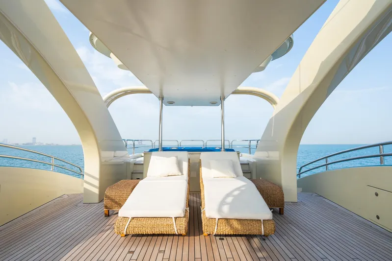Aquamarina Yacht Photos Pics Luxury yacht deck with sun loungers, ISA Isa 470, 2007 model, overlooking the ocean.