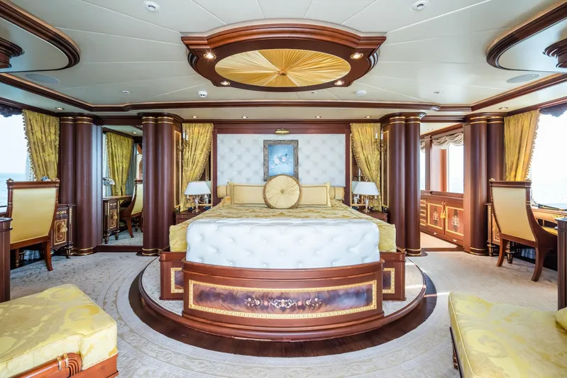 Aquamarina Yacht Photos Pics Luxurious yacht bedroom with elegant decor, featuring a round bed and rich wood accents.