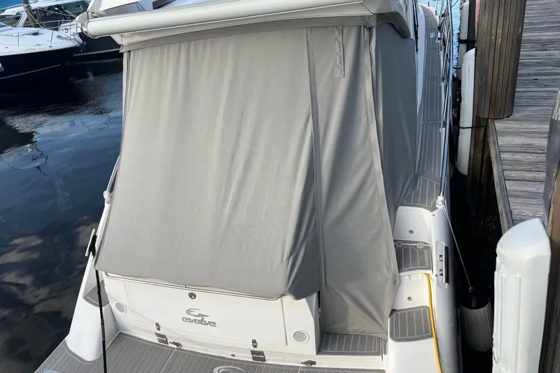 Romaniac Yacht Photos Pics 2021 Evolve 400HT boat with gray cover docked at marina.