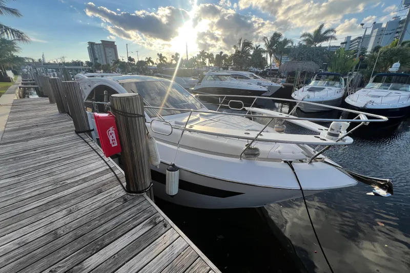 Romaniac Yacht Photos Pics 2021 Evolve 400HT yacht docked at marina under a vibrant sky.