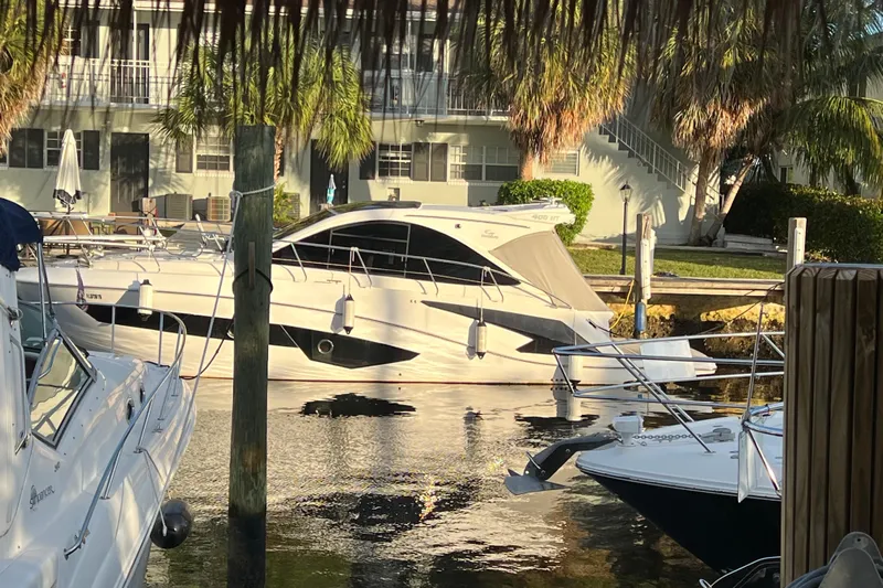 Romaniac Yacht Photos Pics Luxury Evolve 400HT yacht docked in a sunny marina, 2021 model.