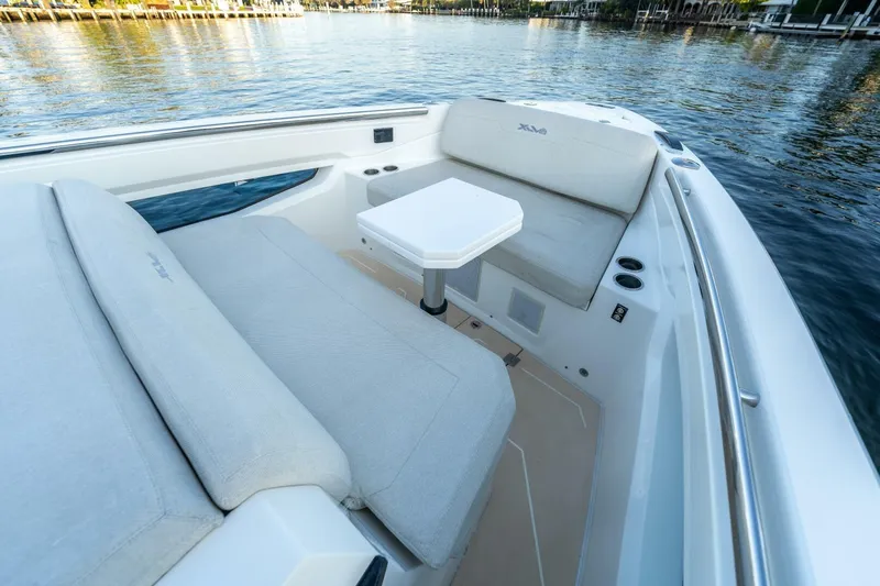  Yacht Photos Pics Luxurious seating area on 2023 Limitless Seas XLV 45 boat, featuring comfortable cushions and a table.