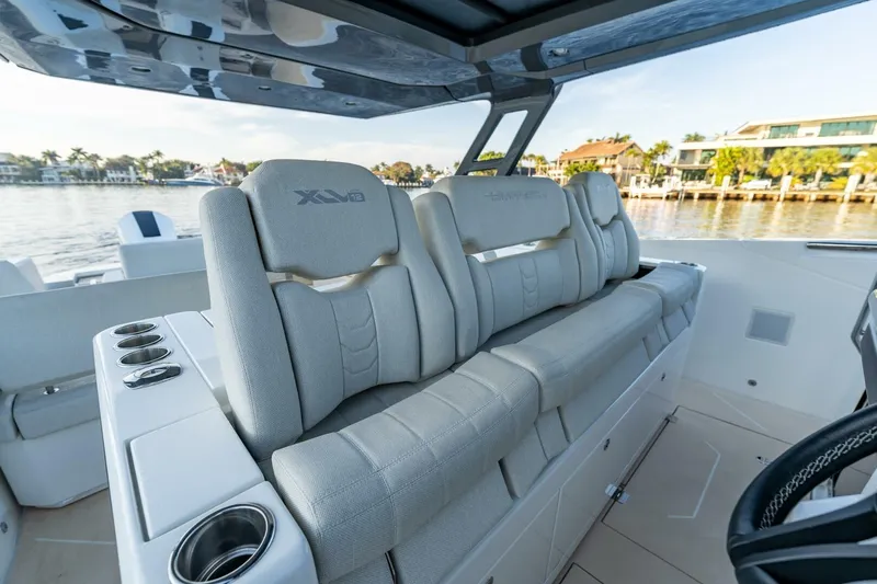  Yacht Photos Pics Luxury seating on 2023 Limitless Seas XLV 45 boat, featuring sleek design and waterfront view.