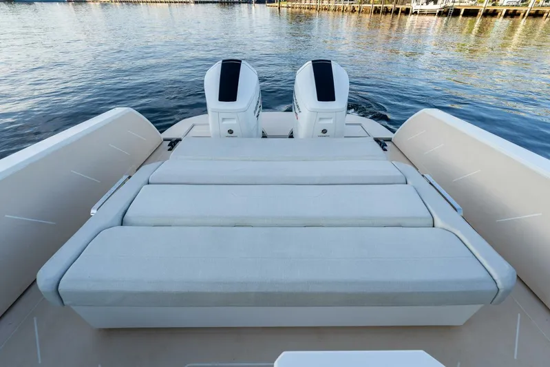  Yacht Photos Pics 2023 Limitless Seas XLV 45 boat with dual engines and cushioned seating, docked on calm water.