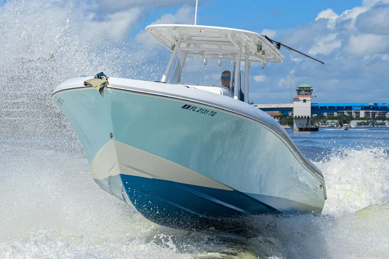  Yacht Photos Pics 2023 Powerplay Powerboats 30 RumRunner cruising on water, creating dynamic waves.