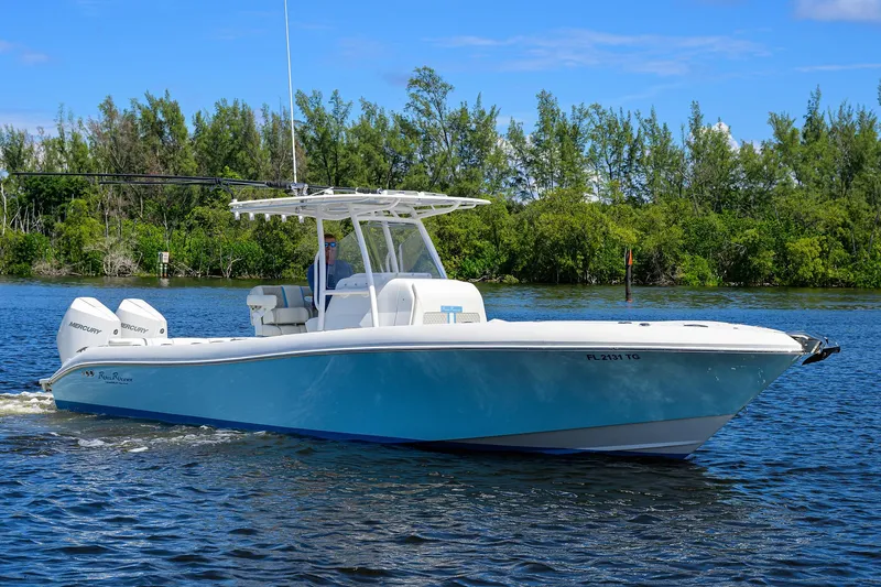  Yacht Photos Pics 2023 Powerplay Powerboats 30 RumRunner cruising on a serene lake.