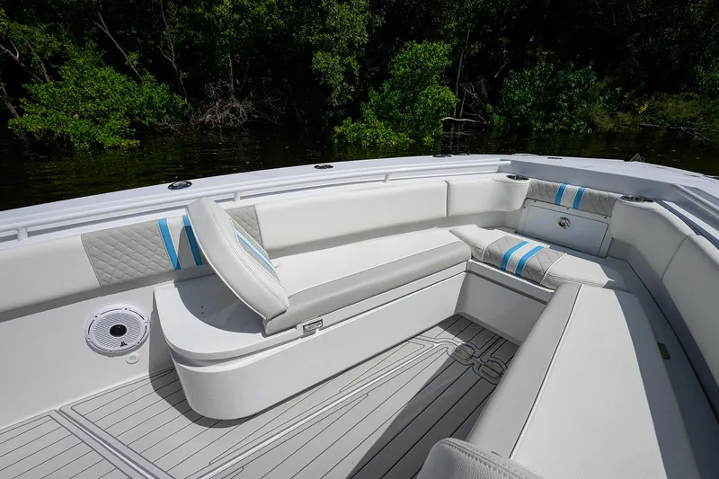  Yacht Photos Pics 2023 Powerplay Powerboats 30 RumRunner interior with white seating and blue accents.