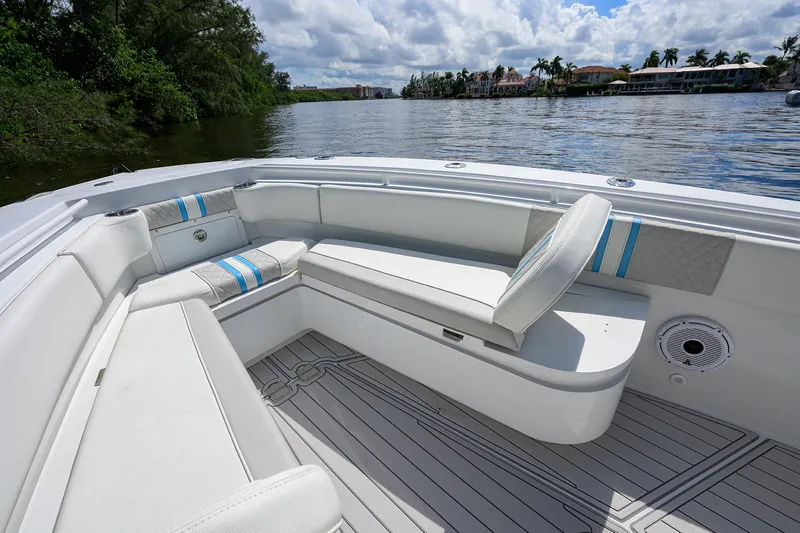  Yacht Photos Pics 2023 Powerplay Powerboats 30 RumRunner interior with white seating, blue accents, and scenic water view.