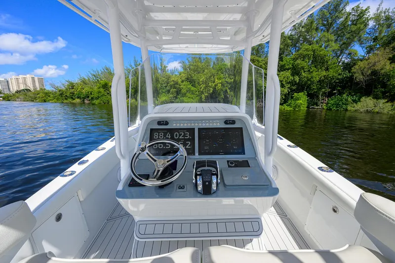  Yacht Photos Pics 2023 Powerplay Powerboats 30 RumRunner cockpit with modern controls on a scenic waterway.