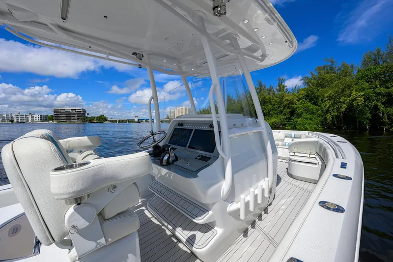  Yacht Photos Pics 2023 Powerplay Powerboats 30 RumRunner on serene water, featuring sleek design and modern controls.