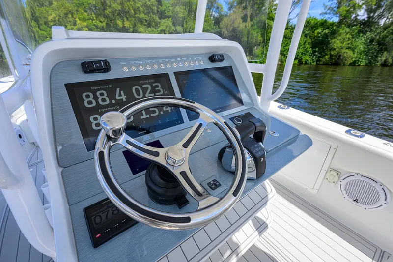  Yacht Photos Pics 2023 Powerplay Powerboats 30 RumRunner dashboard with steering wheel and digital displays.
