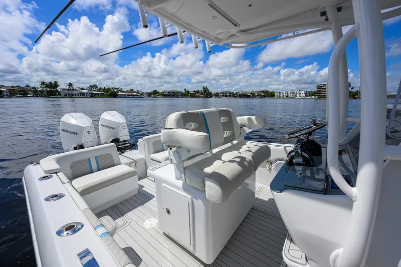  Yacht Photos Pics 2023 Powerplay Powerboats 30 RumRunner on water, featuring luxurious seating and dual Mercury engines.