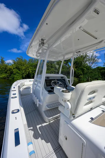  Yacht Photos Pics 2023 Powerplay Powerboats 30 RumRunner, sleek white interior, open water, clear blue sky.