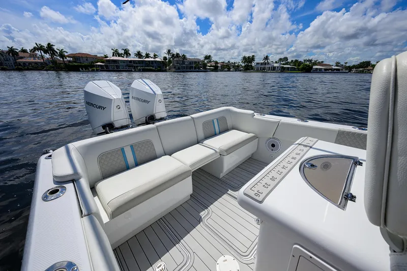  Yacht Photos Pics 2023 Powerplay Powerboats 30 RumRunner on water, featuring spacious seating and dual Mercury engines.