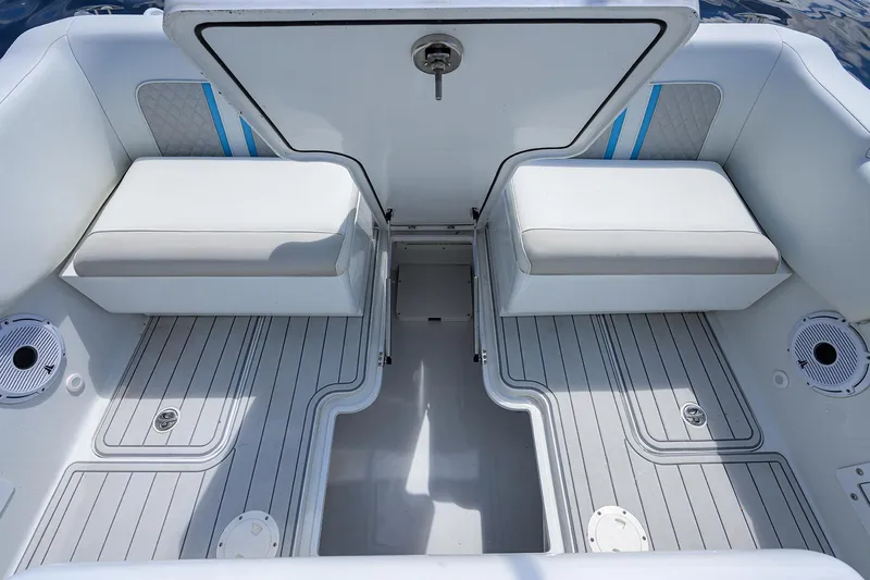  Yacht Photos Pics 2023 Powerplay Powerboats 30 RumRunner interior with cushioned seating and sleek design.