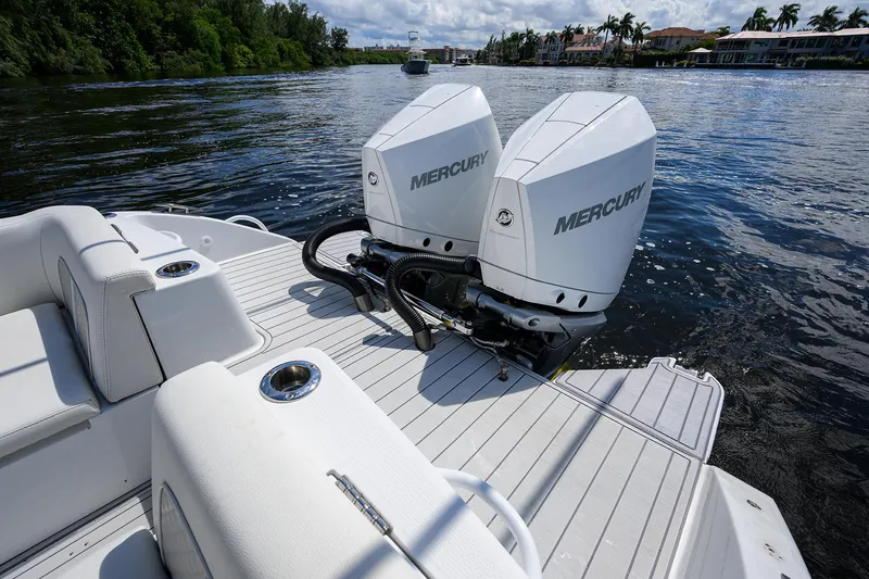  Yacht Photos Pics 2023 Powerplay Powerboats 30 RumRunner with twin Mercury engines on a serene waterway.