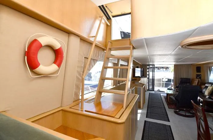  Yacht Photos Pics Interior of 1997 Forbes Cooper 74 Pilothouse yacht with wooden ladder and life preserver.