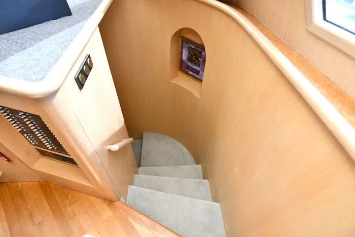  Yacht Photos Pics Staircase in 1997 Forbes Cooper 74 Pilothouse yacht with wooden and carpeted design.
