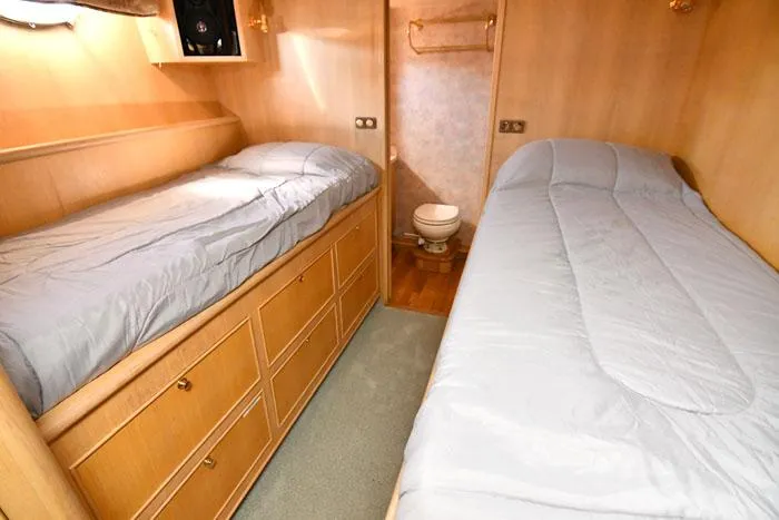  Yacht Photos Pics 1997 Forbes Cooper 74 Pilothouse cabin with twin beds and wooden storage drawers.