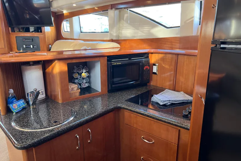 Minnow Yacht Photos Pics Interior of 2006 Carver 39 Motor Yacht kitchen with microwave, sink, and storage.